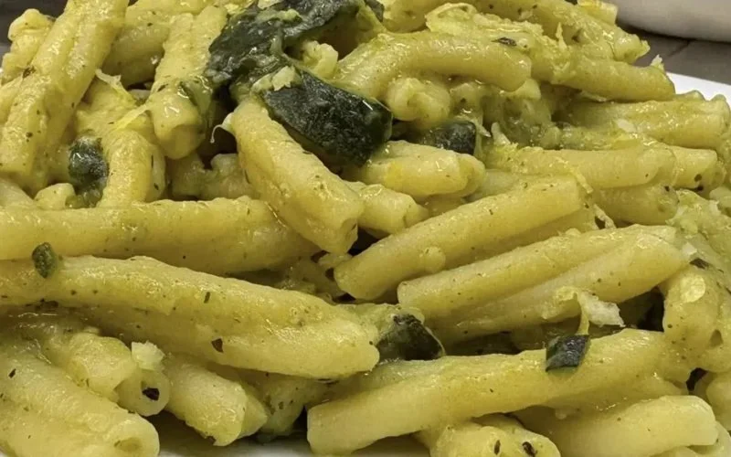 Prato de espaguete marinara servido com molho de tomate fresco e ervas.